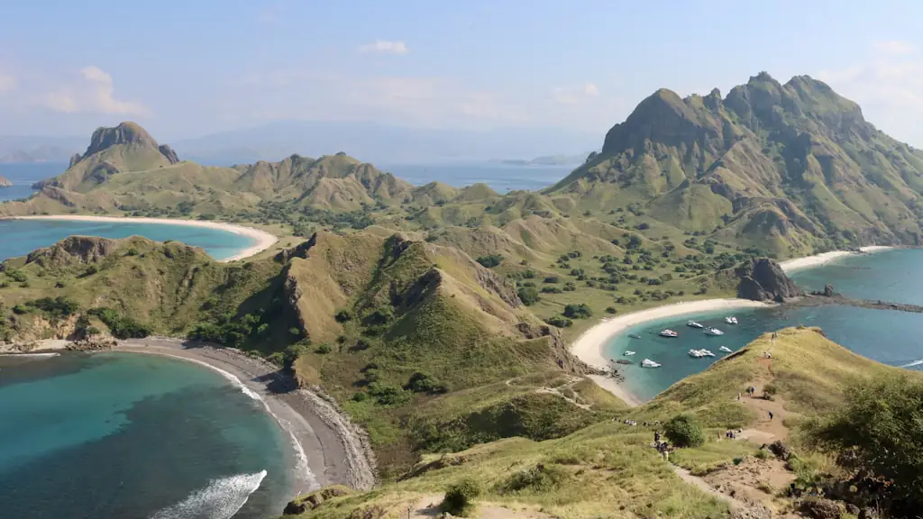 Elevated view over green island ridges, curving white-sand beaches and boats anchored in the bays